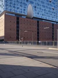 a big building with some windows next to a street corner and a few cars around it