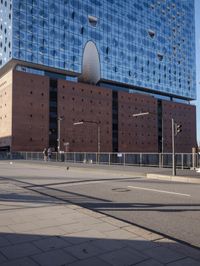 a big building with some windows next to a street corner and a few cars around it