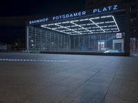 the building is located on one side and on another side is an illuminated sign reading'palmer plaza '