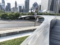 the top of a building next to highway with many tall buildings in the background and buildings on opposite sides