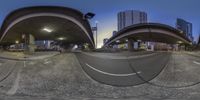 a fisheye lens on a city street at night, showing the camera's angle