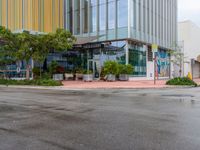 a picture of the outside of a shopping center in front of the road and the sidewalk