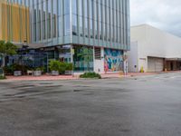 a picture of the outside of a shopping center in front of the road and the sidewalk