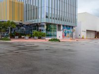 a picture of the outside of a shopping center in front of the road and the sidewalk