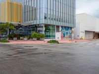 a picture of the outside of a shopping center in front of the road and the sidewalk