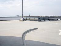 a boat is parked in an empty parking lot near an air port on the water