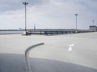 a boat is parked in an empty parking lot near an air port on the water