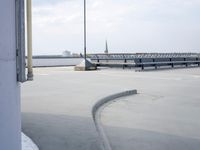a boat is parked in an empty parking lot near an air port on the water