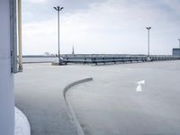 a boat is parked in an empty parking lot near an air port on the water