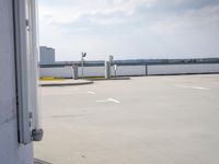 a boat is parked in an empty parking lot near an air port on the water