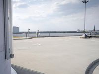 a boat is parked in an empty parking lot near an air port on the water