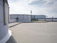 a boat is parked in an empty parking lot near an air port on the water
