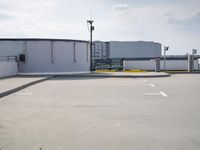 a boat is parked in an empty parking lot near an air port on the water