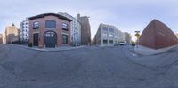 a fish eye lens view of a neighborhood with red brick buildings and a street sign