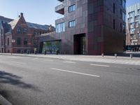 an empty street and an outside building on an urban day with a red and silver exterior