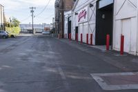 an empty street with traffic cones and parked cars on either side of it, with a sign near the end stating the space is empty