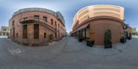 a fish eye view of some buildings and trees outside, in front of an office building