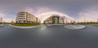 a 360 - view photo of a street and a large modern building on either side of the road