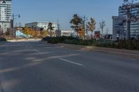 two empty street in front of an urban area and tall buildings in the background, with no cars on the side