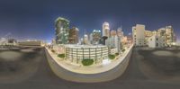 city buildings are in the background as seen through a fisheye lens at night time