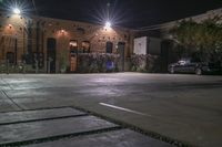 car parking lot in urban area at night with headlights on and lights on cars are in the garage