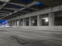 an empty parking garage with no people in it at night time time with only one stop sign