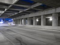 an empty parking garage with no people in it at night time time with only one stop sign