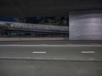 an image of a long road under the bridge in an underground place on the street