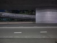 an image of a long road under the bridge in an underground place on the street