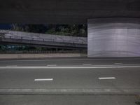 an image of a long road under the bridge in an underground place on the street