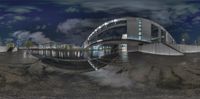 the reflection of a night view shows a building and a pond in front of it