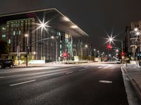 a car driving by the building at night time in motion with light trails coming out of it