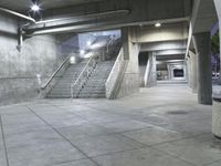 concrete steps are lined with concrete handrails and trees in the background at night