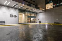 empty walkway at night outside an office building in the city with its entrance sign visible