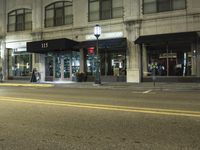 the store has black signage in it and red lights outside of it that say 13
