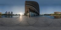 this is a circular panoramic photo from outside the museum, looking down towards a pool and buildings