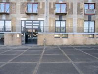 a parking lot with the doors opened to a building with balconies on it