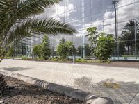 an empty plaza with brick pavers and trees in front of modern building in urban setting