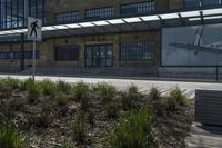 the building with glass is next to a cross walk with an open airway in front