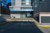 a tall building has a very large window next to it's outside walkway with a concrete curb