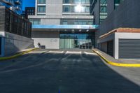 a tall building has a very large window next to it's outside walkway with a concrete curb