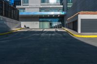 a tall building has a very large window next to it's outside walkway with a concrete curb