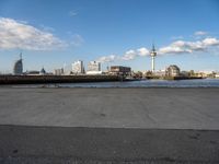 a view of the city from across the river, and with the riverwalk in the foreground