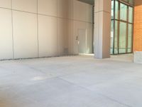 two grey blocks sitting next to a tall building on a sidewalk in front of grass