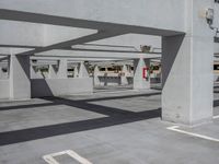 parking garage with two long empty space for cars, a parking meter and parking meters