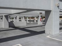 parking garage with two long empty space for cars, a parking meter and parking meters