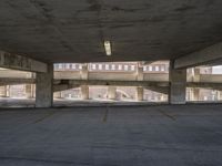 a large cement parking lot with lots of windows and no cars parked nearby and there are multiple empty spaces