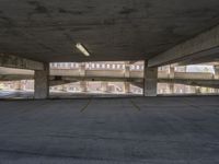 a large cement parking lot with lots of windows and no cars parked nearby and there are multiple empty spaces