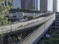 an overpass in the city with cars on it and traffic driving underneath it under a bridge