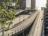 an overpass in the city with cars on it and traffic driving underneath it under a bridge